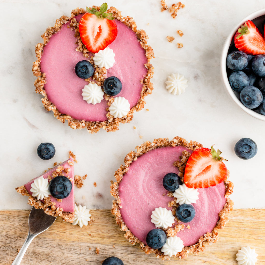 Vegan Strawberry & Elderberry Tart with coconut cream, blueberries, raw date coconut crust, cashew cream and elderberry syrup